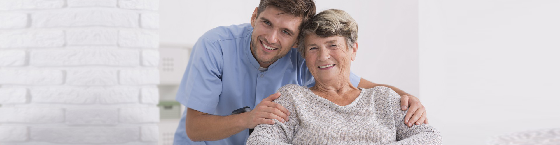 Caregiver smiling together with elderly woman